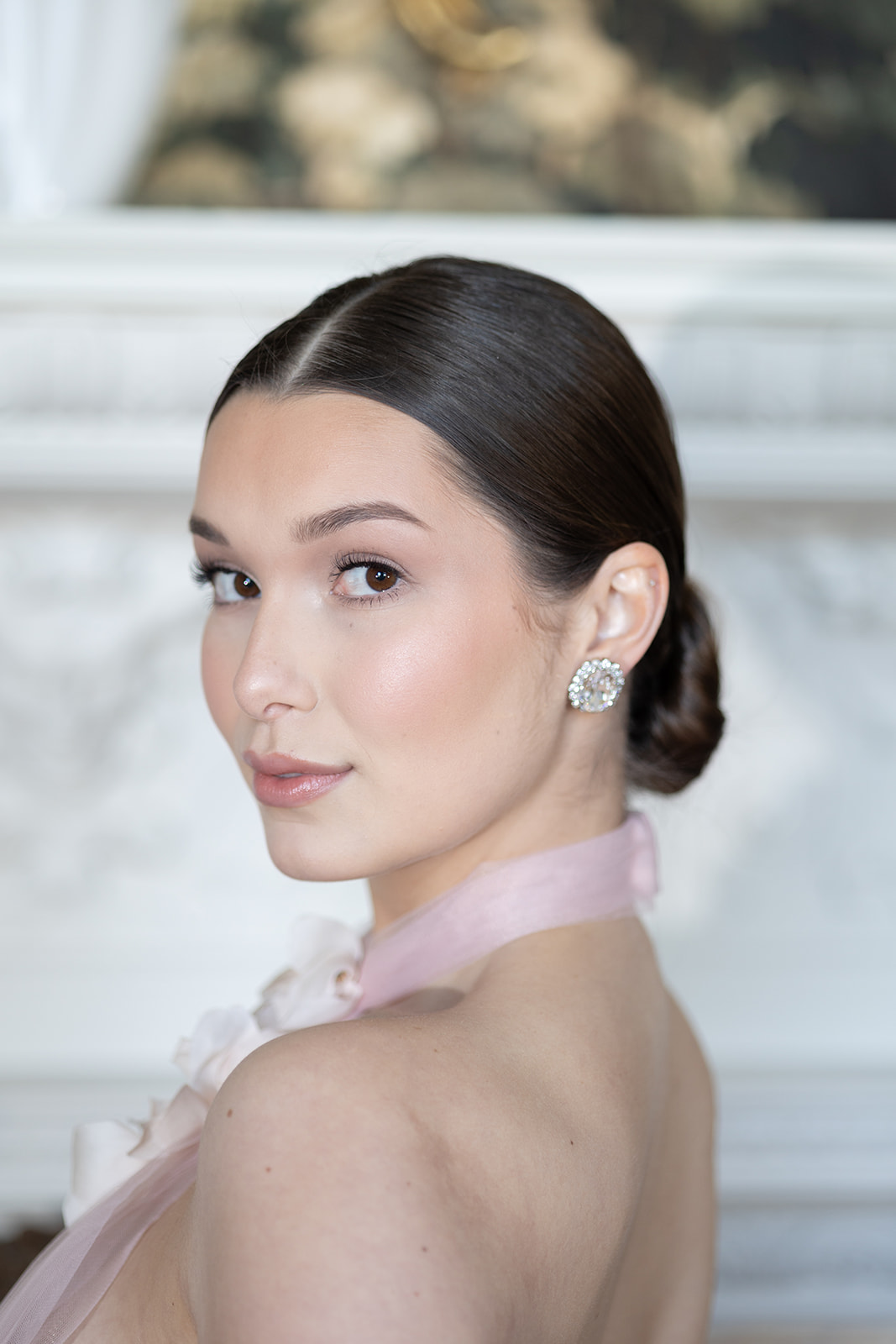 Clean girl aesthetic makeup look on beautiful bride Clover paired with a centre parted slick low bun, perfect for a Hampshire Bride getting married at Stansted House